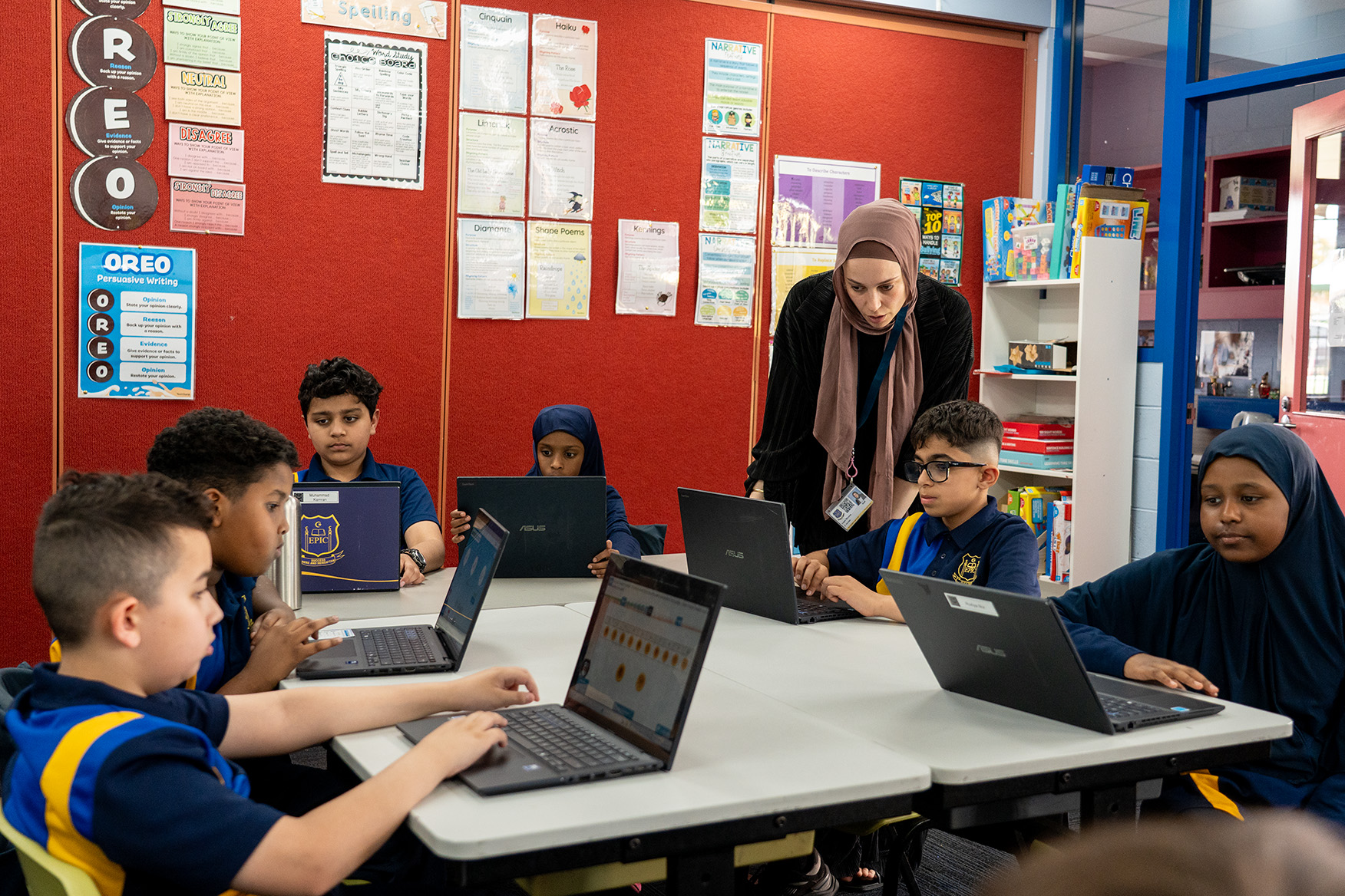 Two people working on laptops